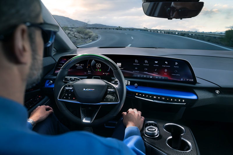 Front View of the 2026 OPTIQ-V Driving Through the Dusk Utilizing its Headlights | Mildenberger Motors in Hamilton Montana MT