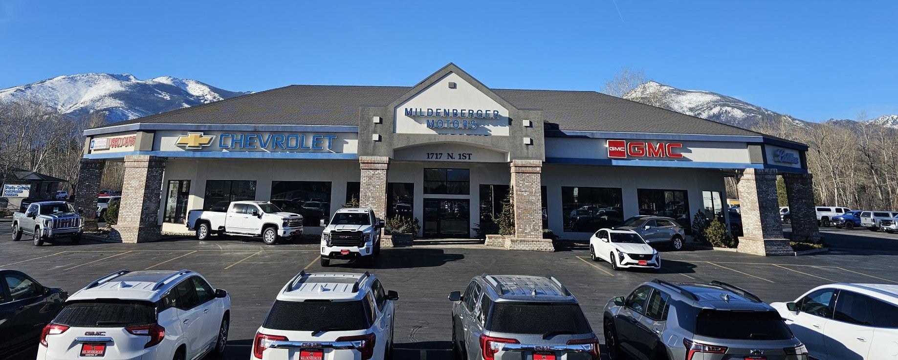 A dealership building with “MILDENBERGER MOTORS” on the facade and 